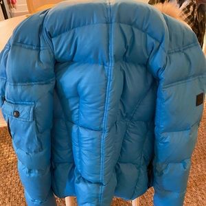 Blue SAM jacket with a fur good.